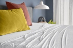 breeze white sheet set on a dressed bed
